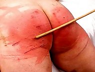 Fat Ass slave Ariel gets her wide bottom caned and flogged until its pulsating and red